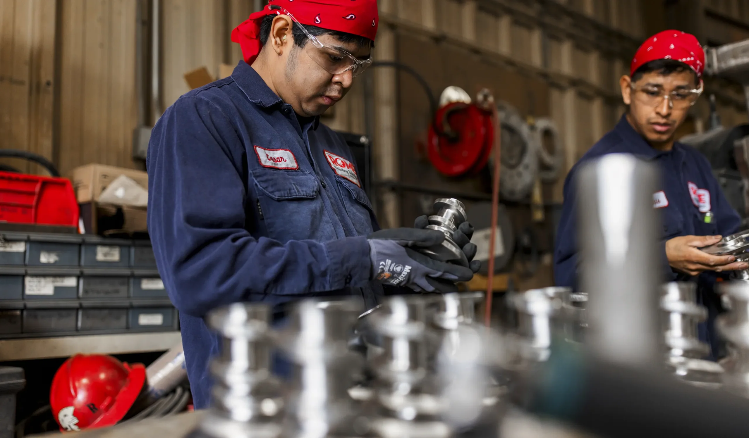 two men indoor workers in Rome uniform blue kits working with tools over the table