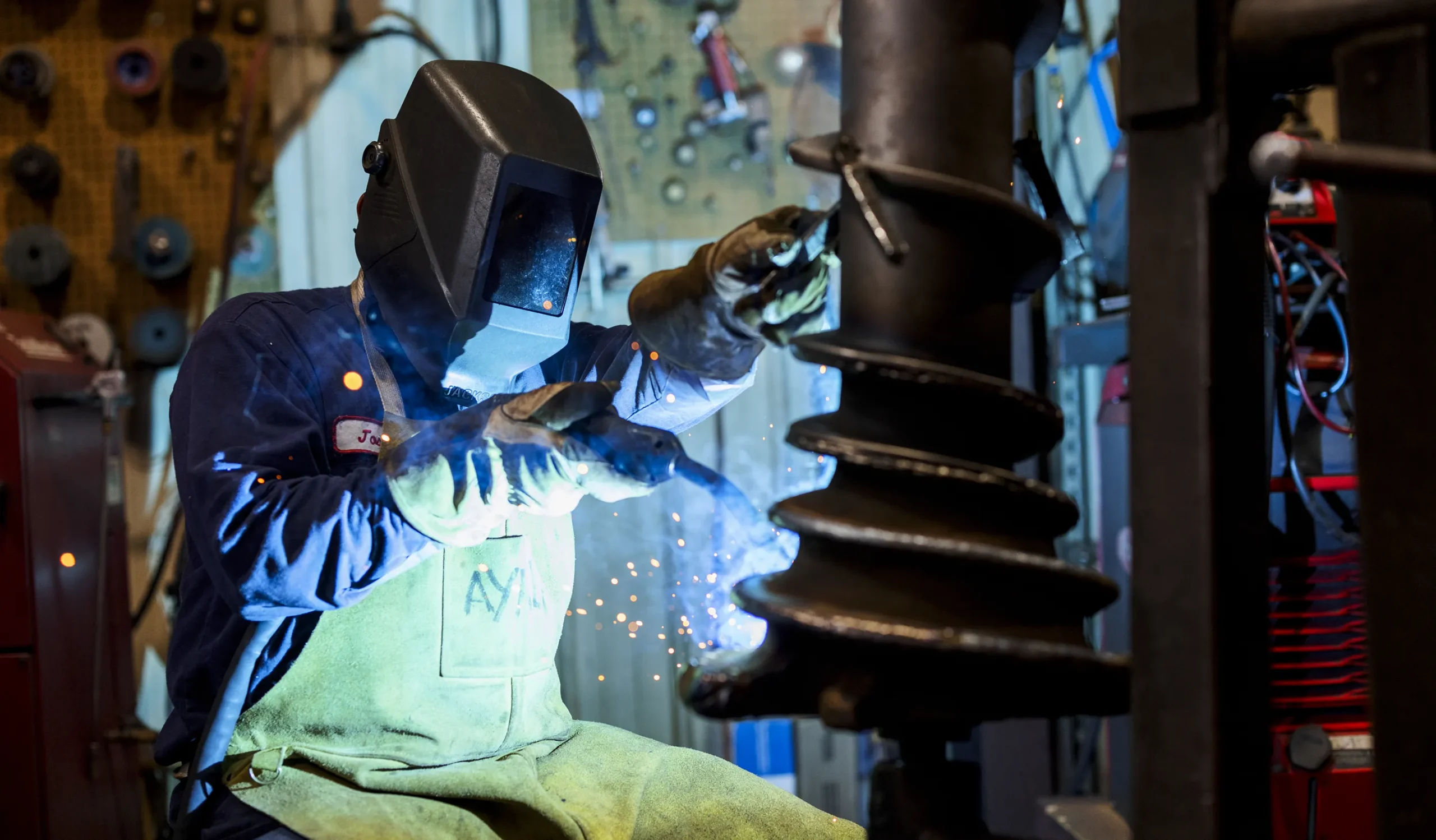 Blade Sharpening Benefits- Left section image showing worker repairing or shapening something