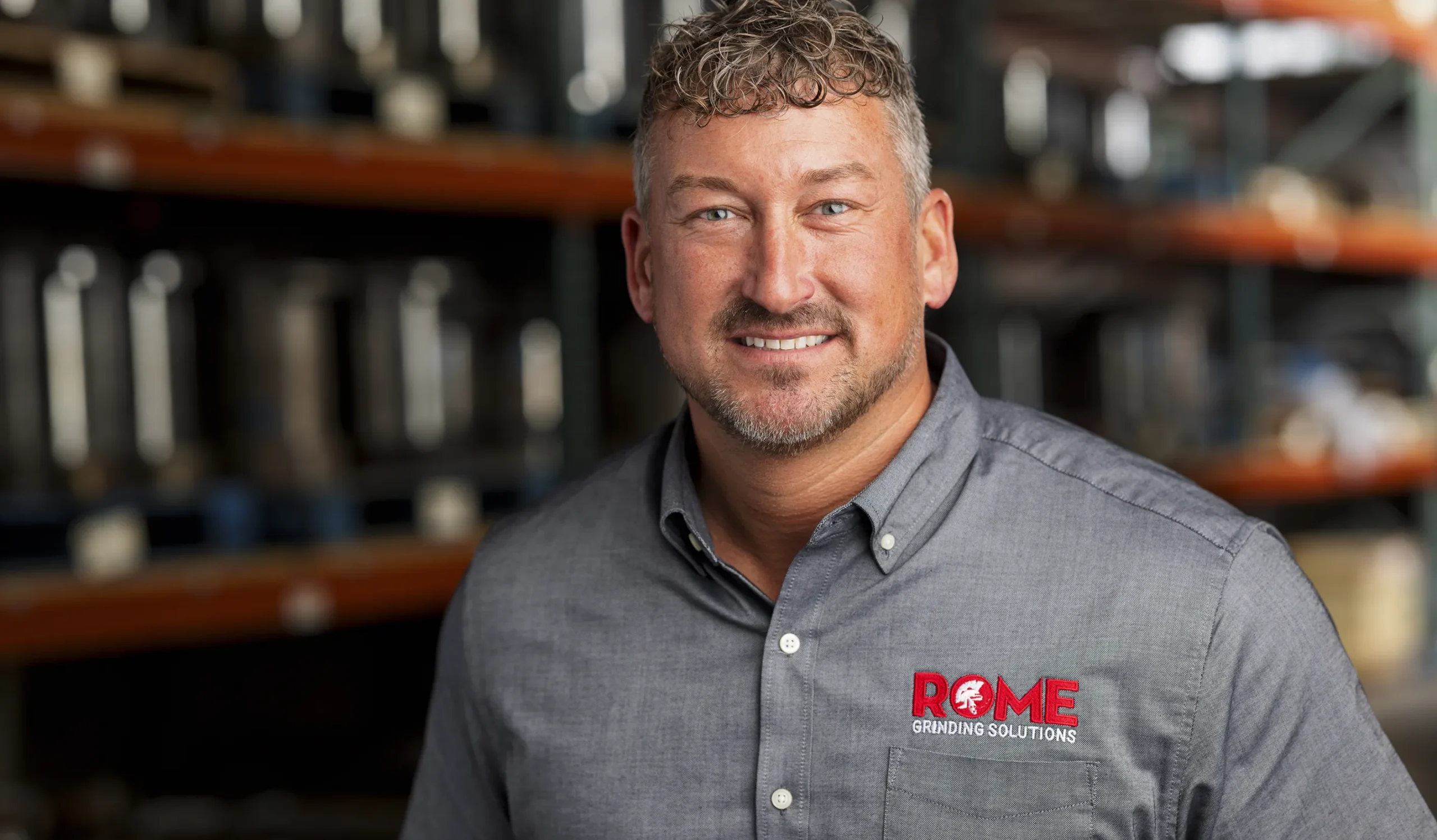 man in gray short with rome logo displayed
